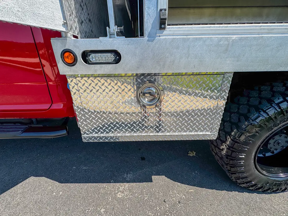 Lower side compartment interior view with fold-down door and storage cavity.